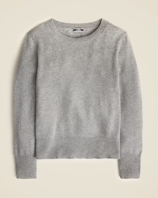 a gray crewneck sweater in front of a plain backdrop