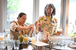 Carla Hall pouring drinks with a mixologist