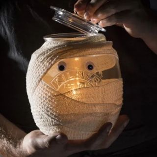 A kilner jar wrapped in bandage to look like a mummy