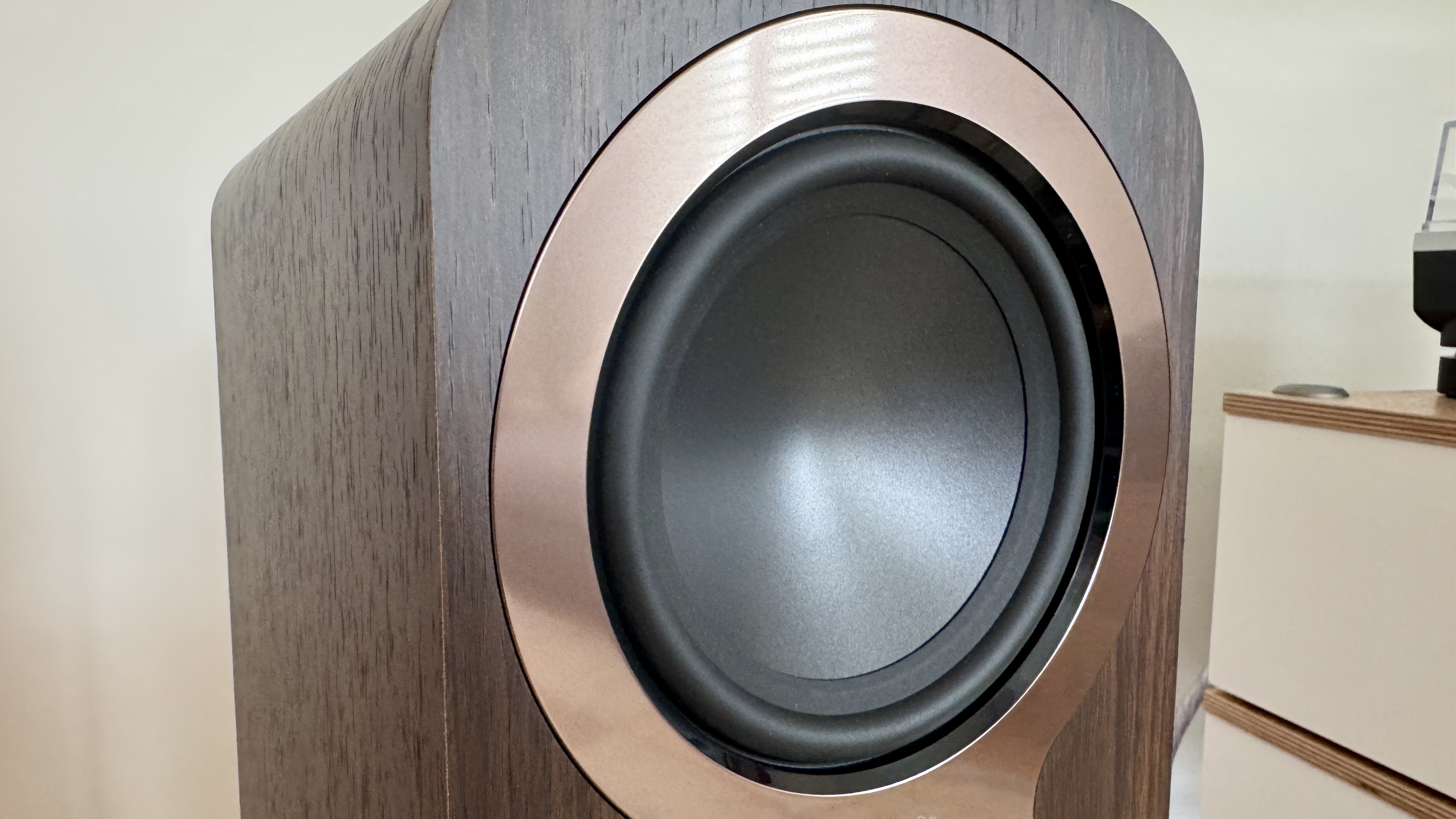 Q Acoustics 3040c speakers in a white listening room, with a hi-fi stack and turntable between them