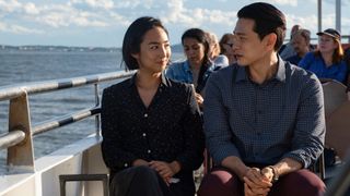 Greta Lee and Teo Yoo sitting on a ferry in Past Lives