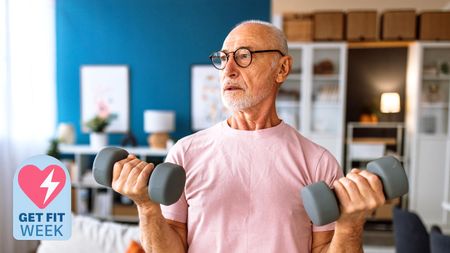 a senior man holding two dumbbells