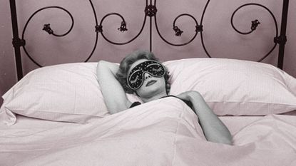 Woman wearing sleep mask getting beauty sleep