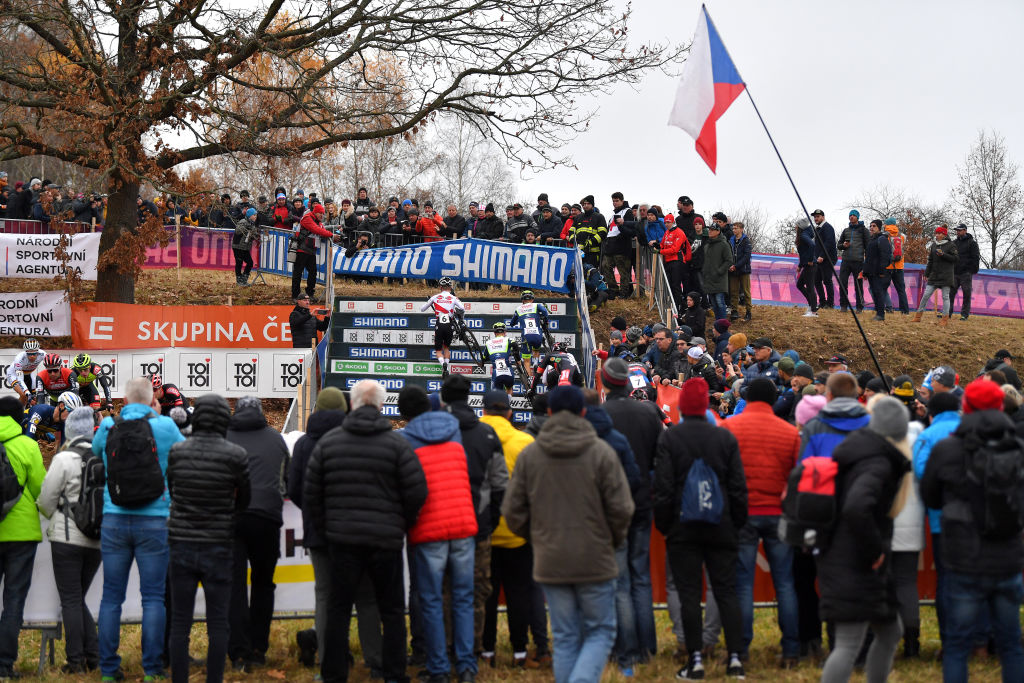 TABOR CZECH REPUBLIC NOVEMBER 14 A general view of Eli Iserbyt of Belgium and Team Pauwels Sauzen Bingoal Corne Van Kessel of Netherlands and Tormans Cyclo Cross Team and Quinten Hermans of Belgium and TormansCircus Cyclo Cross Team compete while fans cheer during the 25th Tabor UCI CycloCross Worldcup 2021 Mens Elite CXWorldCup on November 14 2021 in Tabor Czech Republic Photo by Luc ClaessenGetty Images