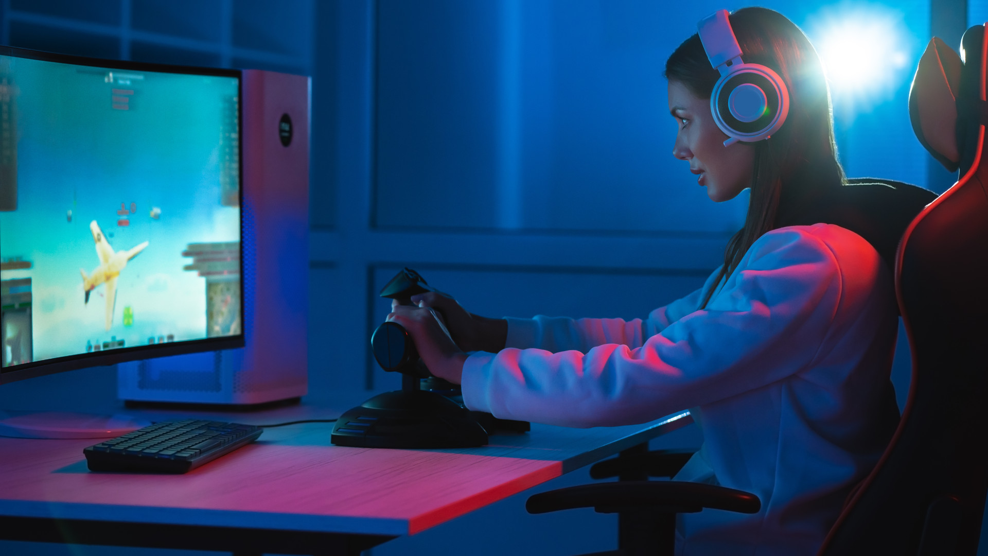 A woman playing a flight simulation game on her gaming PC