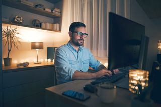man working from home in front of monitor