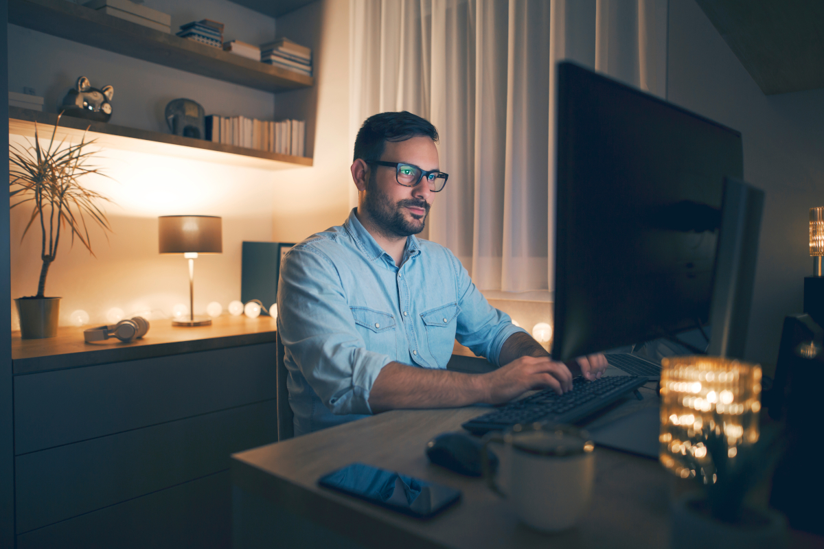 A man working from home in front of a screen