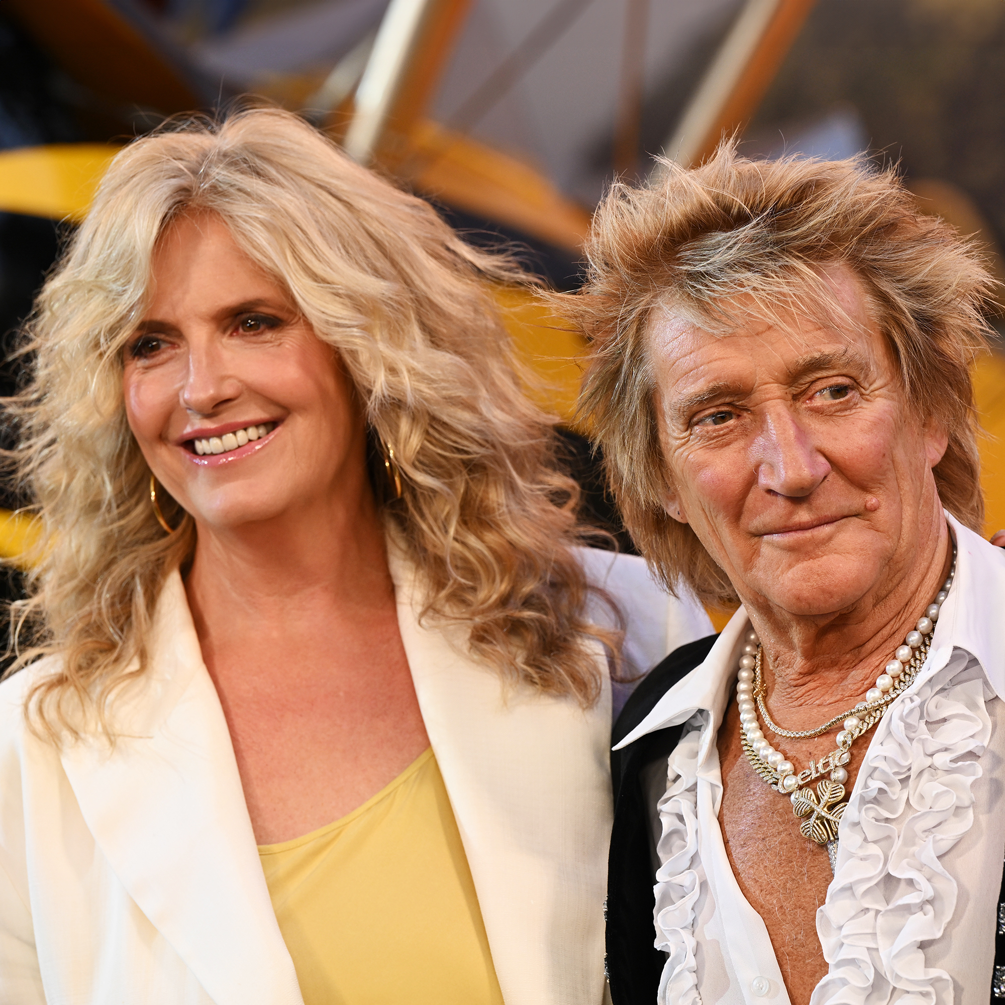 Penny Lancaster and Rod Stewart attend the Global Premiere Red Carpet in support of "Mission: Impossible - The Final Reckoning", with a yellow plane just visible in the background