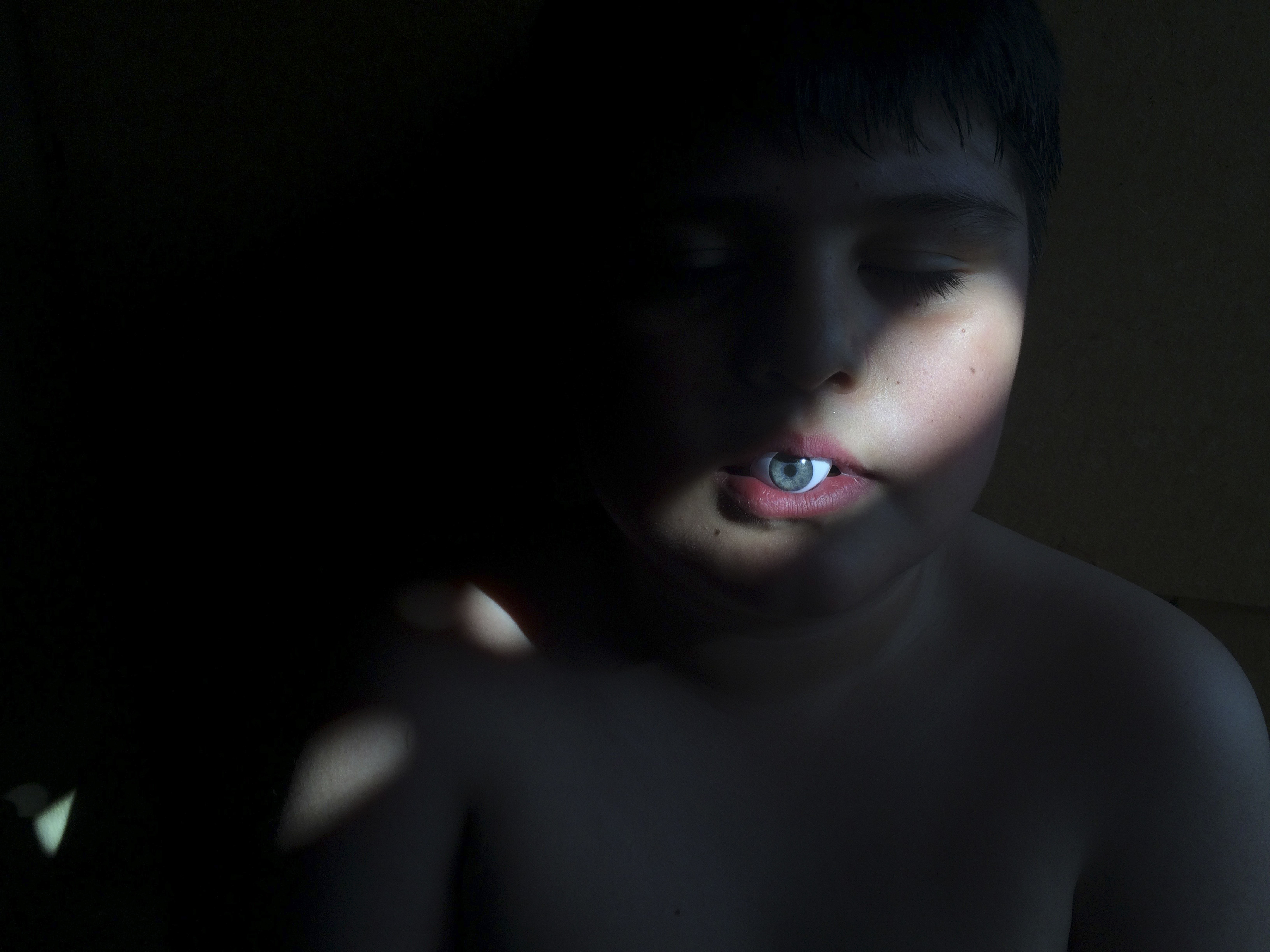 The Watchman shot of a child with an fake eyeball in his mouth for iPhone Photography Awards 2021