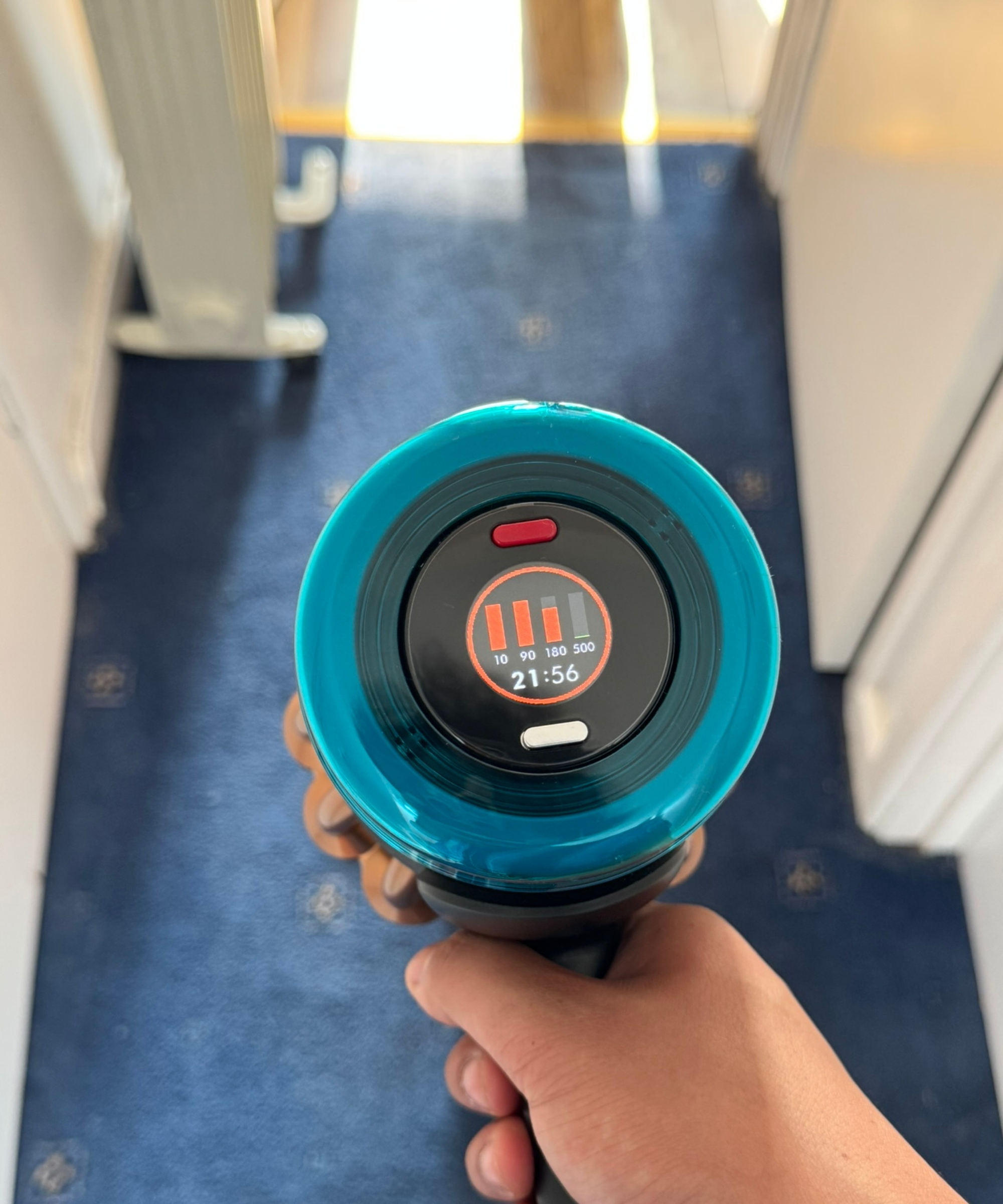 Closeup of the Dyson V16 Piston Animal's display screen while vacuuming carpet.