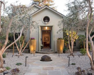 Modern front porch with olive trees and symmetrical planters
