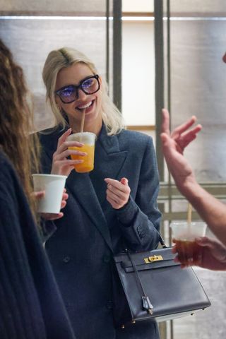 Kendall Jenner at Paris Fashion Week wearing an oversize suit and an Hermes Kelly bag