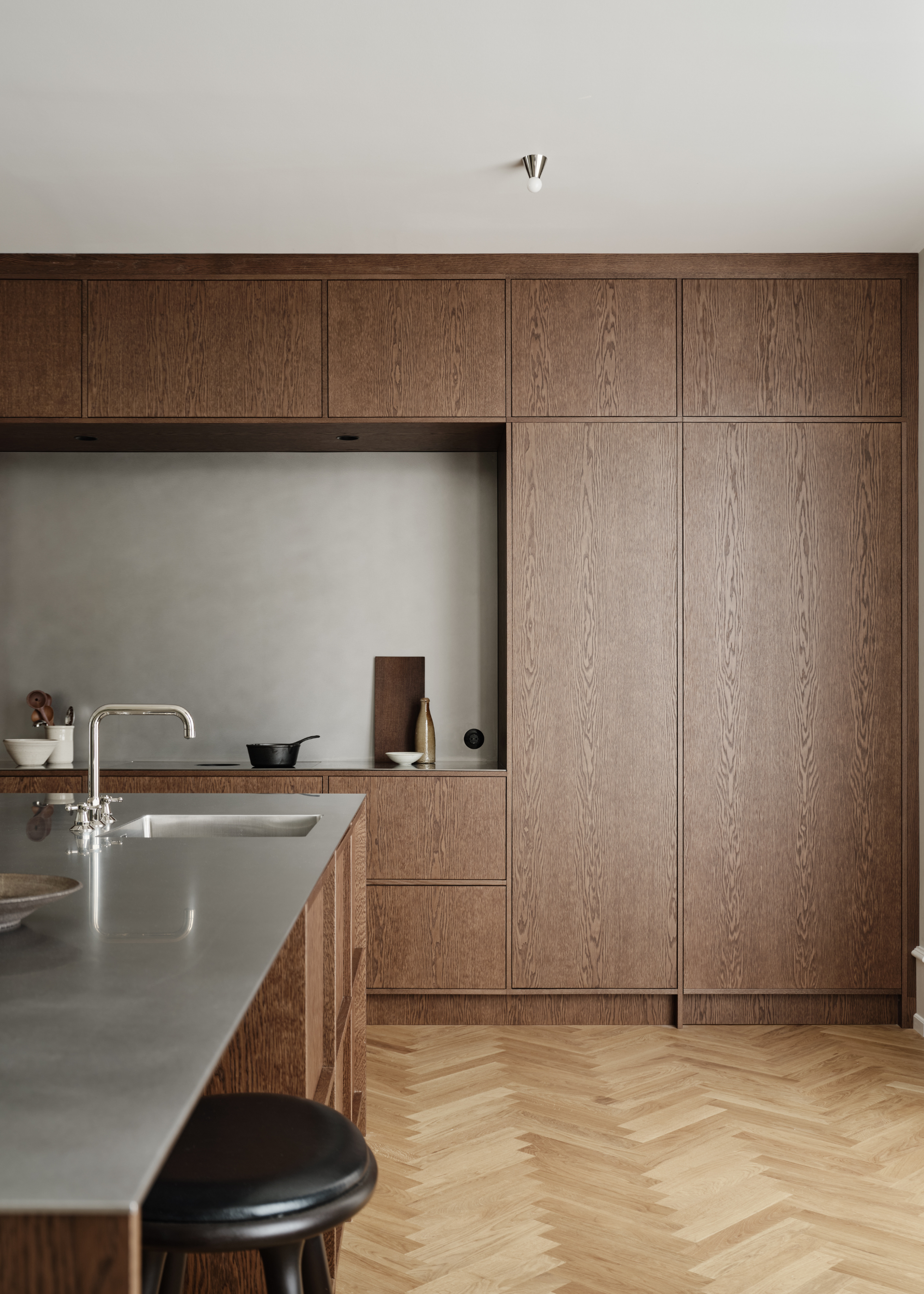 chic wooden kitchen with steel splashback and steel counter