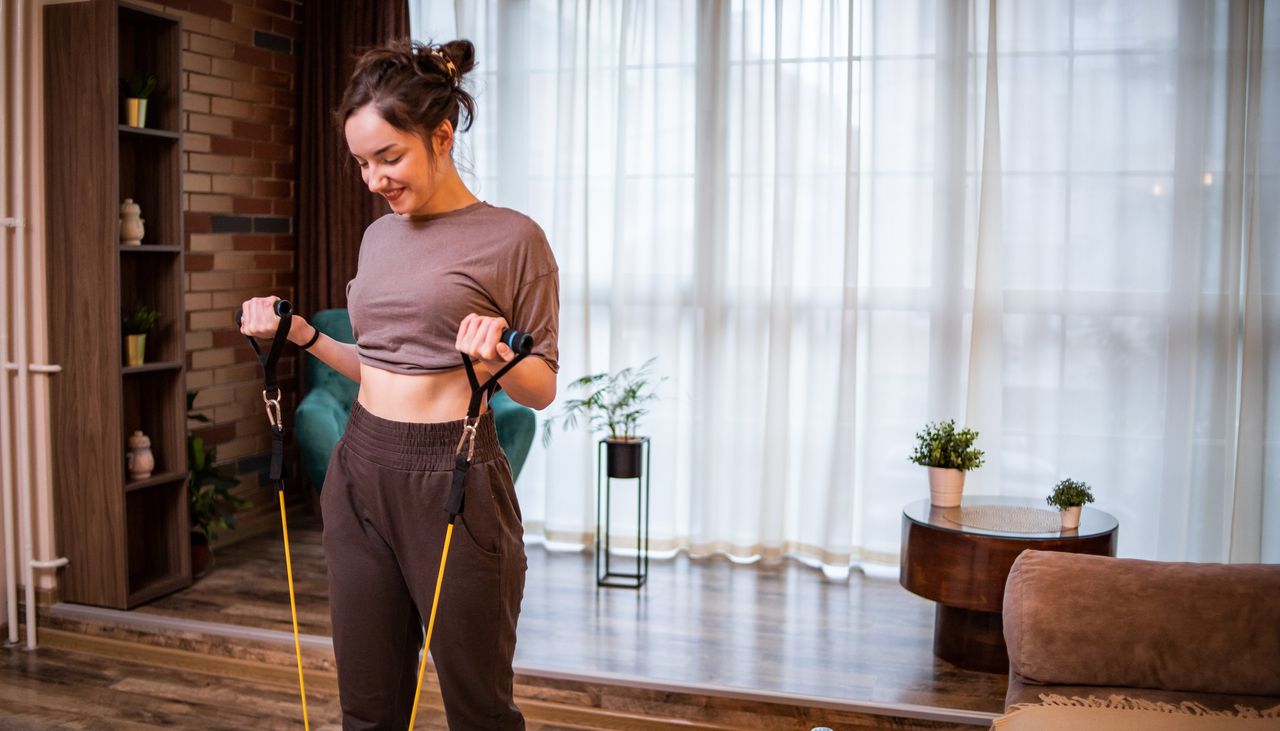 Woman using resistance bands at home