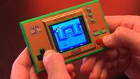 Screenshot of modded Zelda Game and Watch featured in Macho Nacho Productions with A Link to the Past gameplay on screen.