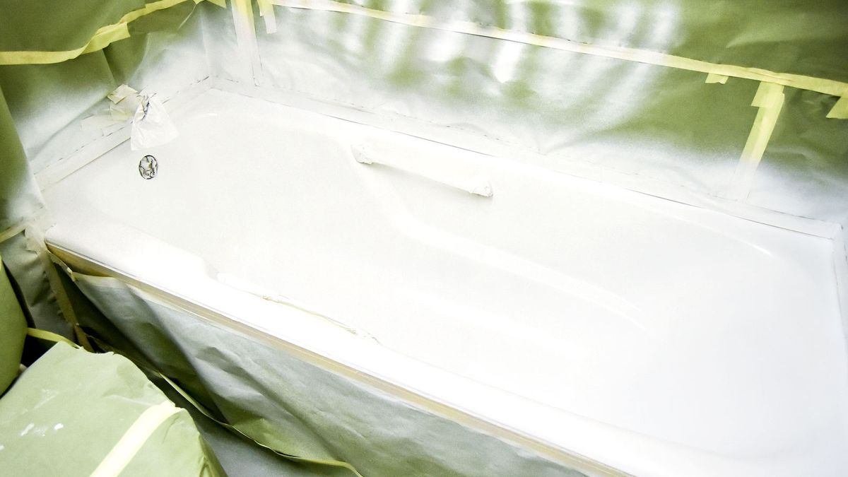 White re-enameled bath with green protective sheeting