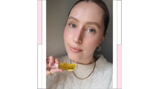 Naomi wearing and holding the Gisou lip oil