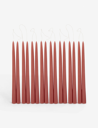 eight pairs of burnt orange long tapered candles