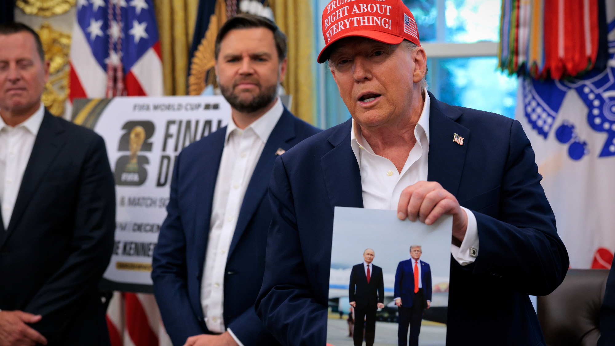 President Donald Trump shows off photo of him and Russia's Vladimir Putin