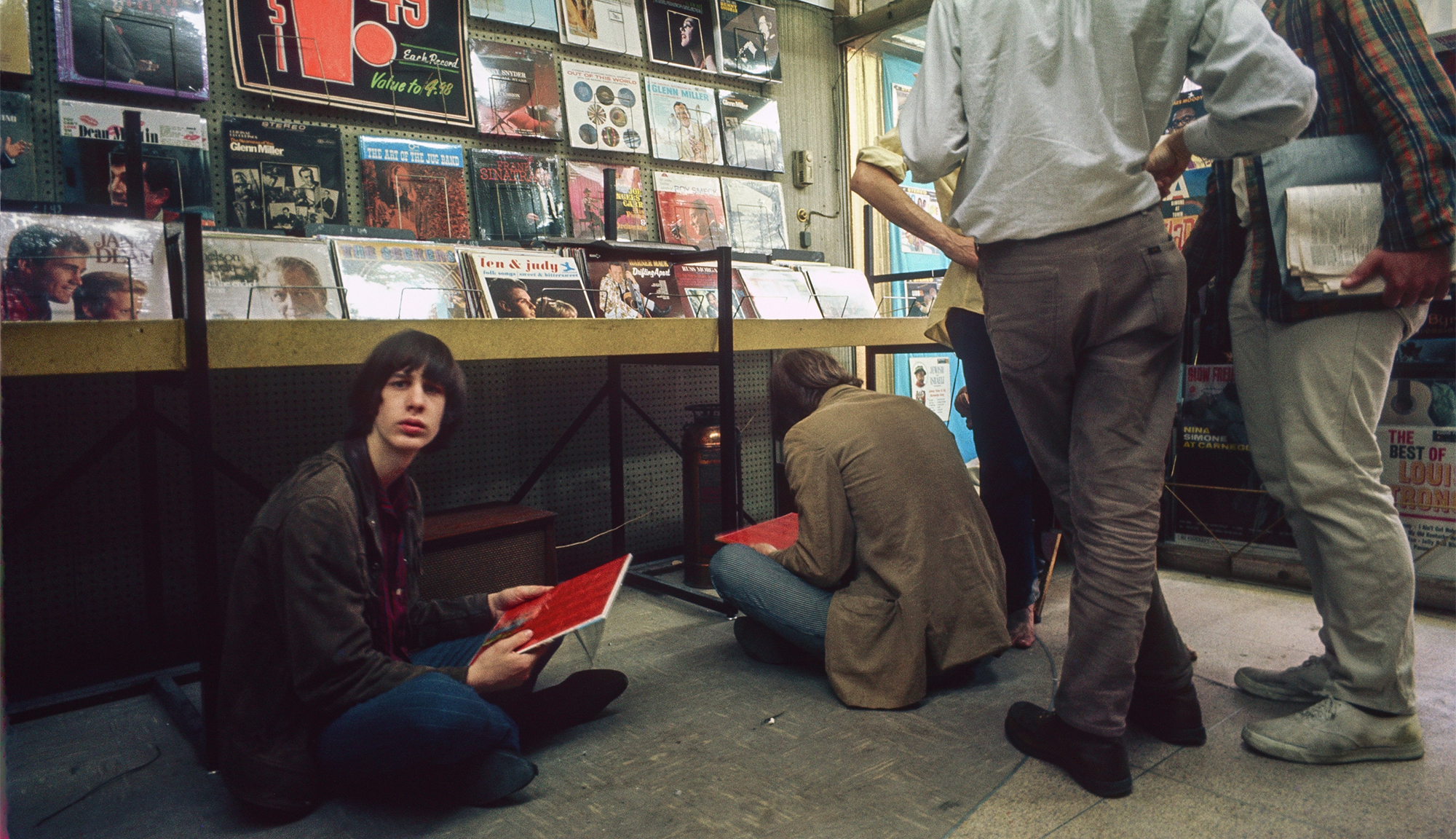 18-year-old Todd Rundgren sits on the floor at the Record Mart, Philadelphia, June 1967. He holds a copy of the Beatles' 'Sgt Pepper&amp;Otilde;s Lonely Hearts Club Band' album, which had just been released.