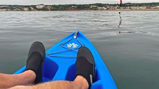 Man wearing Lomo 3mm Wetsuit Booties on kayak