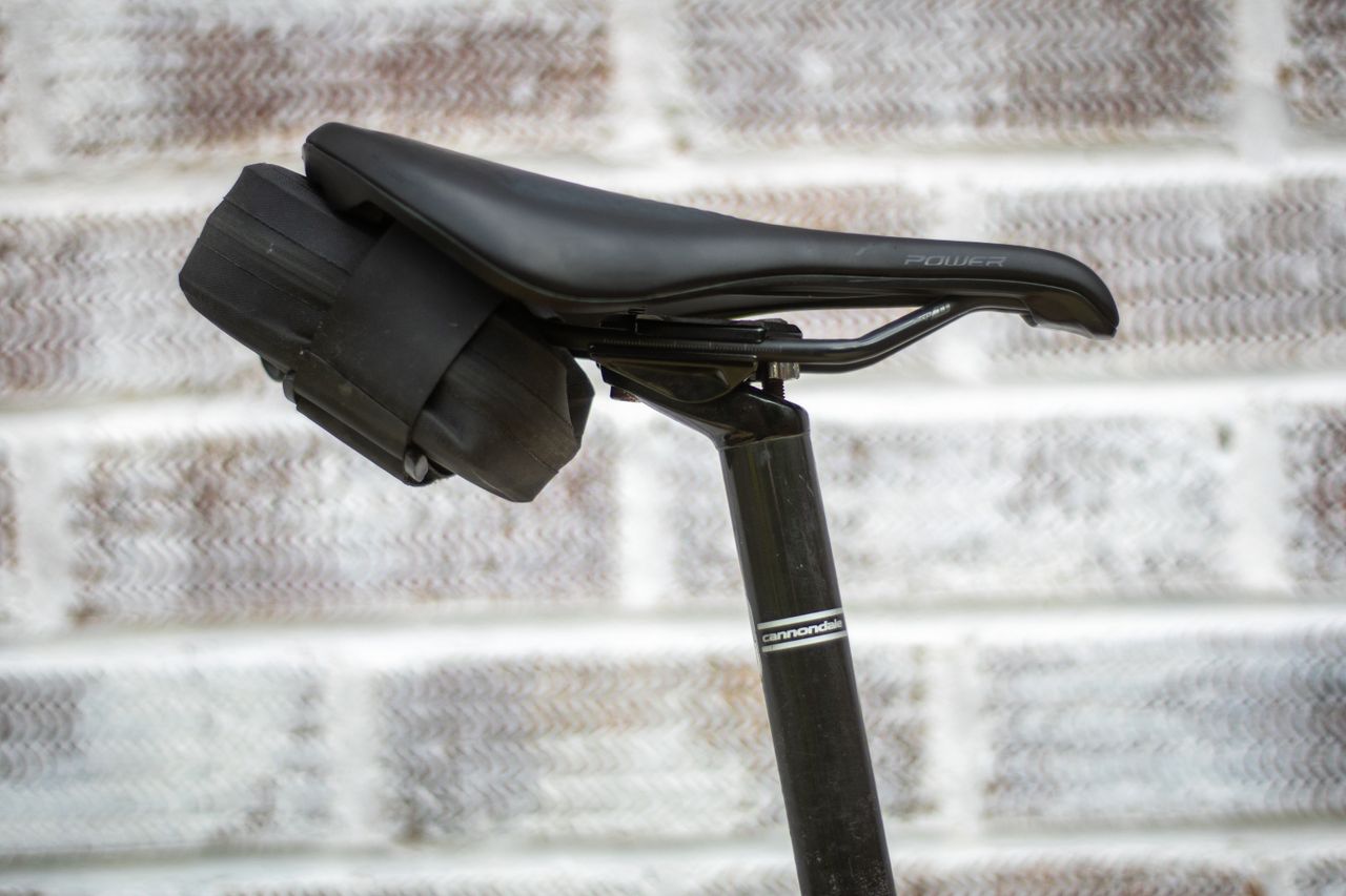 Small Zefal Z road pack saddle bag in black tucked under saddle and attached to rails with velcro