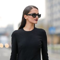 Best lipsticks for pale skin - Gabrielle Caunesil wears black sunglasses, a black long sleeves / long slit dress from Prada - gettyimages 1469086752