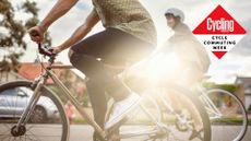 Image shows a person riding a commuter bike.