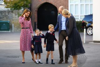 Helen Haslem (right), head of the lower school greets Princess Charlotte as she arrives for her first day of school, with her brother Prince George and her parents the Duke and Duchess of Cambridge, at Thomas's Battersea in London on September 5, 2019 in London, England