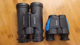 Photo of the Occer 12x25 compacy binoculars next to Celestron Outland X 10x42 binoculars to show the difference in size