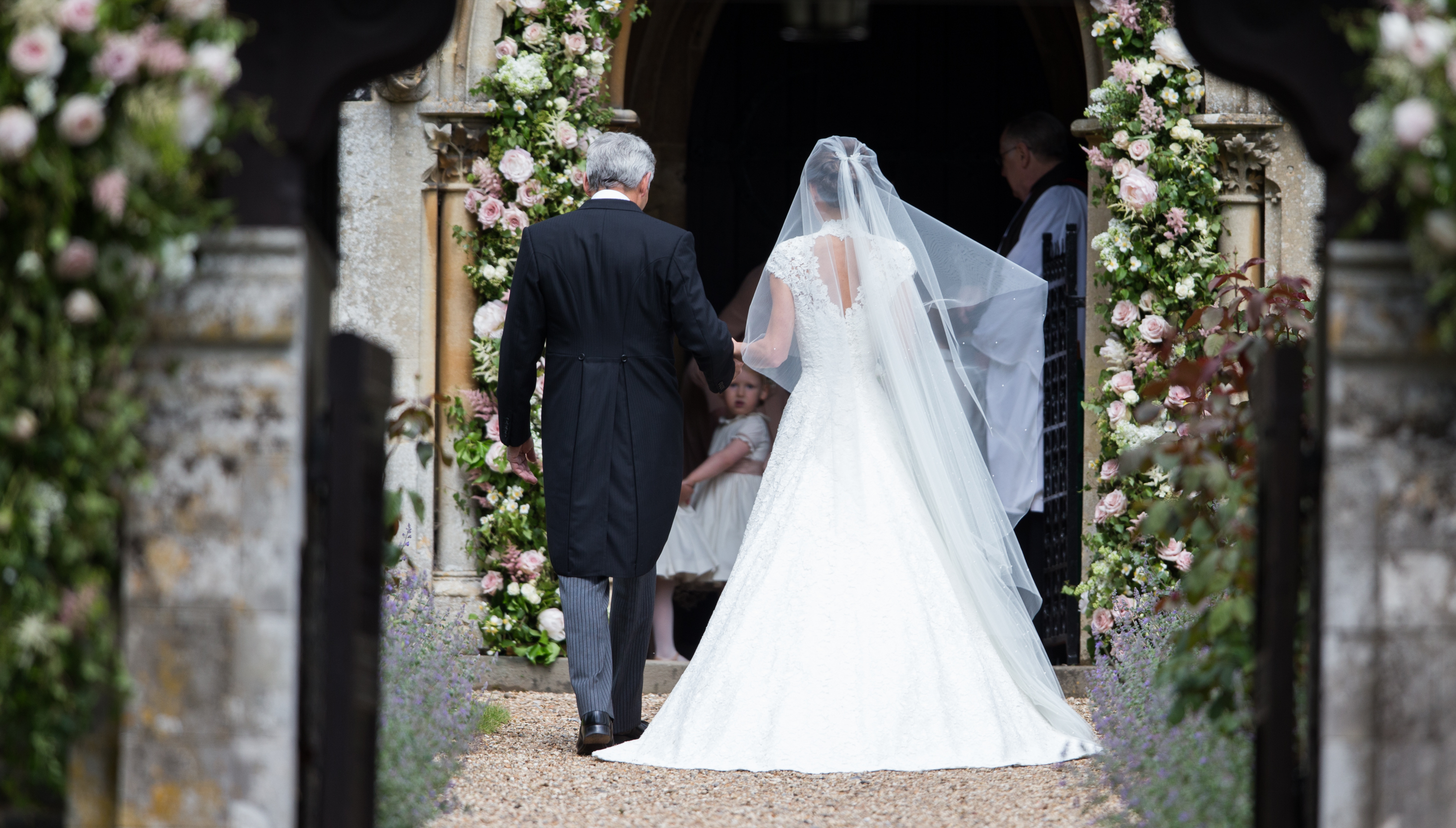 The back of Michael Middleton walking Pippa down the aisle on her wedding day