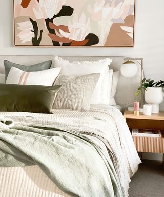 double bed in bedroom with fresh bedding, bedside table and abstract art print