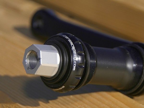 The aluminum spindle attaches to the driveside arm with a seven-sided taper.