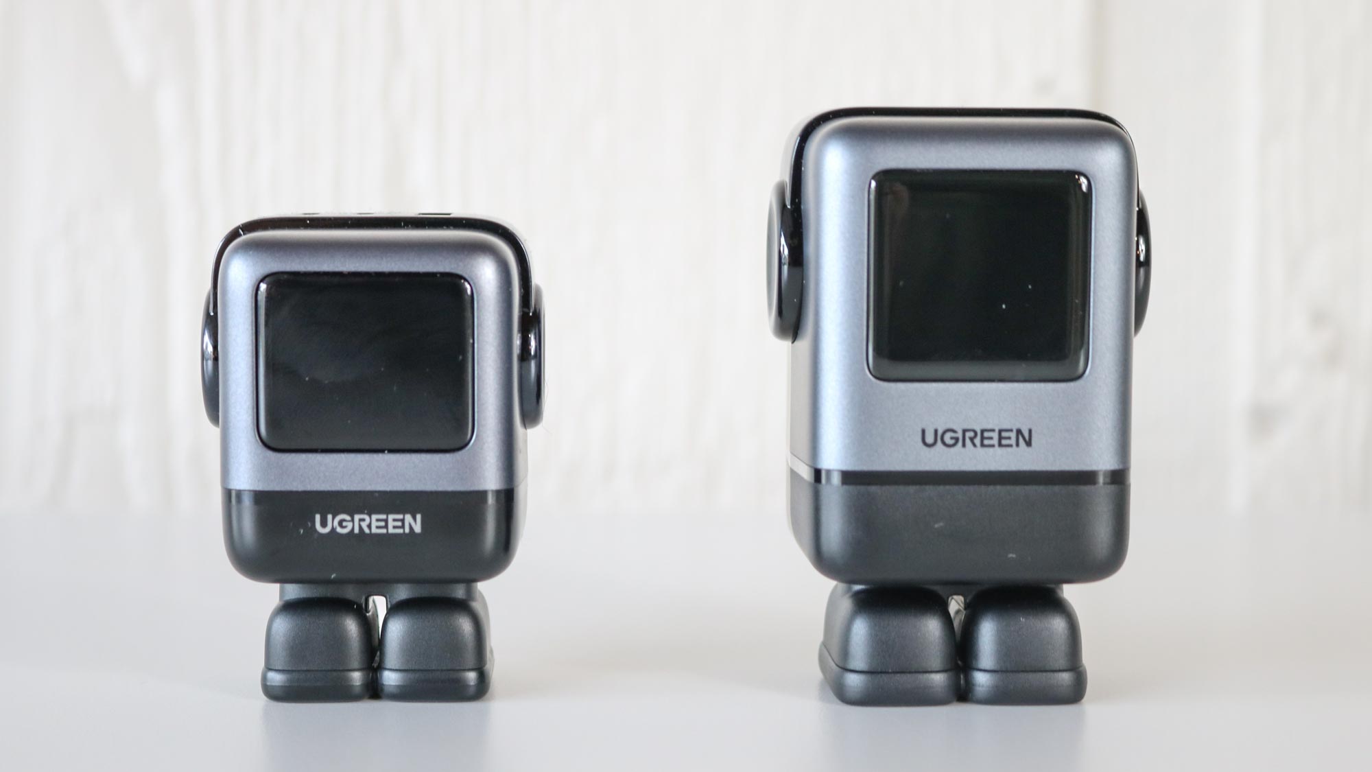 The 65W and 100W versions of the Ugreen Uno Charger side by side on a table