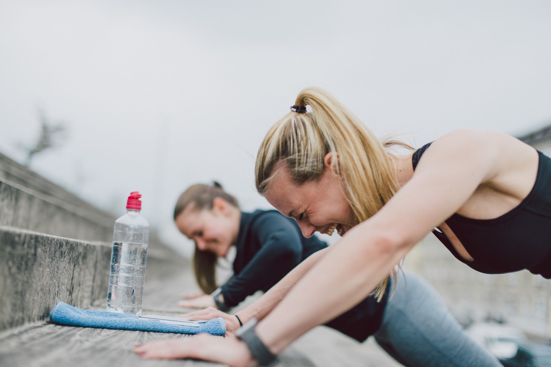Types of headaches: Girlfriends doing push-ups together