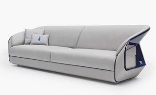 Pale grey sofa with a sloping back and Bugatti logo