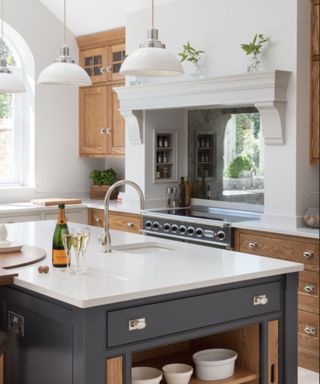 Dark grey and wood kitchen cabinets with white Caesarstone countertops