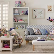 living room with floral sofa cushions and shelves
