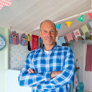 men with bunting flag and clock on wall