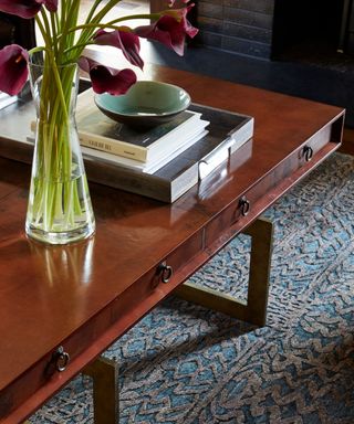 A vintage rug under a wooden coffee table