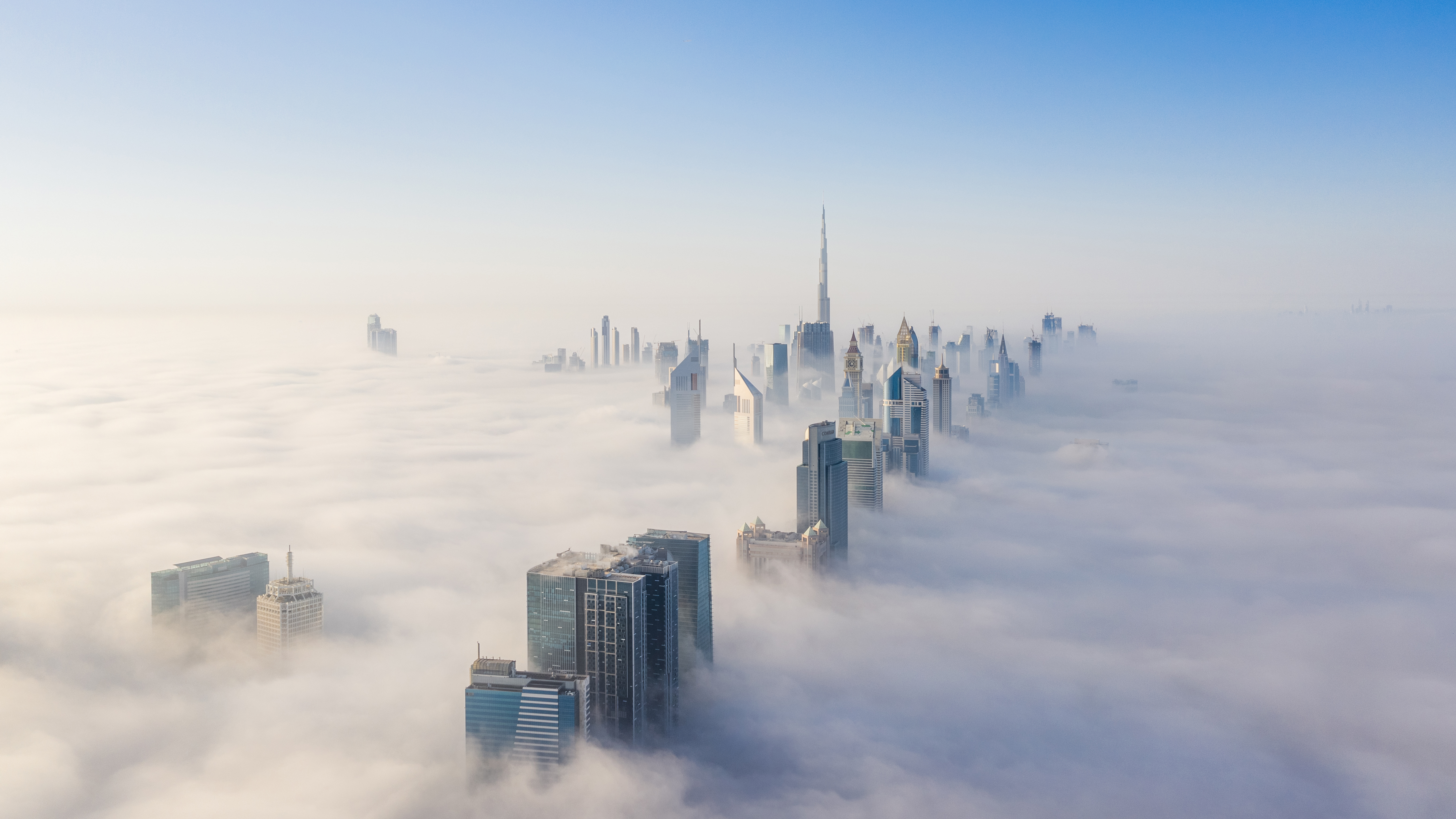 Dubai skyline poking through low-hanging clouds