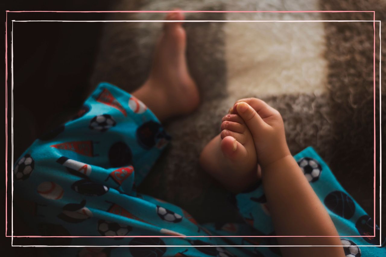 A toddler in pajamas has a skin rash from hand, foot, and mouth disease. Photo is only of his feet.