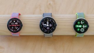 Three Google Pixel Watch 3 models on a wooden display