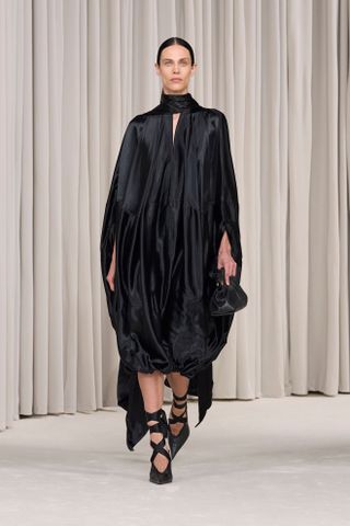 A Ferragamo runway model wearing an all-black outfit in the spring/summer 2025 collection.