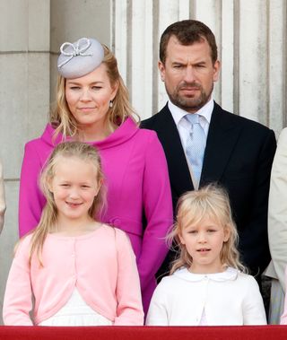 Autumn Phillips, Peter Phillips, Savannah Phillips and Isla Phillips watch a flypast from the balcony of Buckingham Palace
