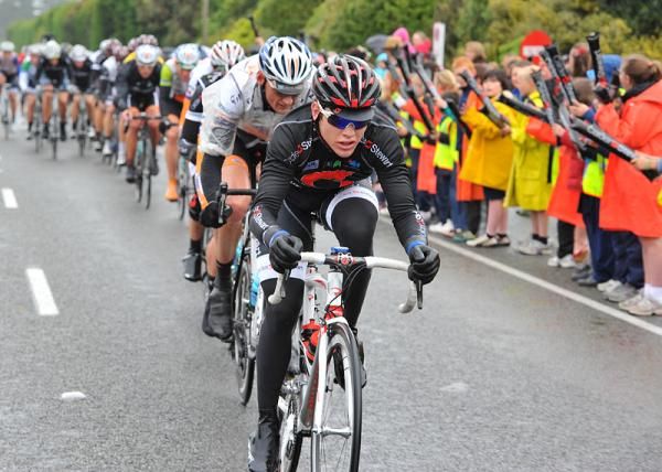 Calder Stewart continue to lead the peloton past the cheering crowds