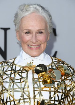 Actress Glenn Close in a white and gold jacket.