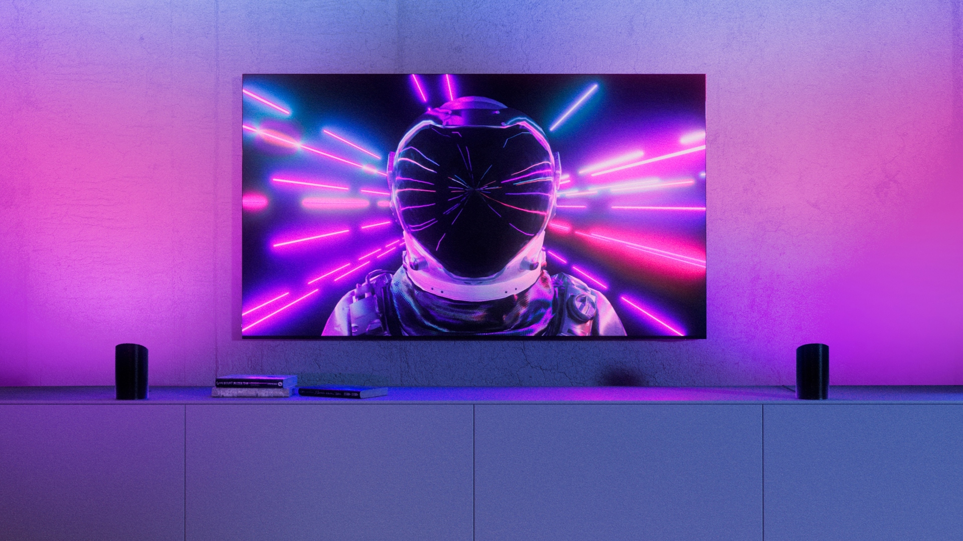 A person wearing a helmet on a TV screen with Philips Hue lighting around