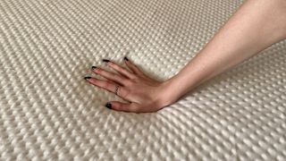 Person's hand pushing on SleepOvation mattress