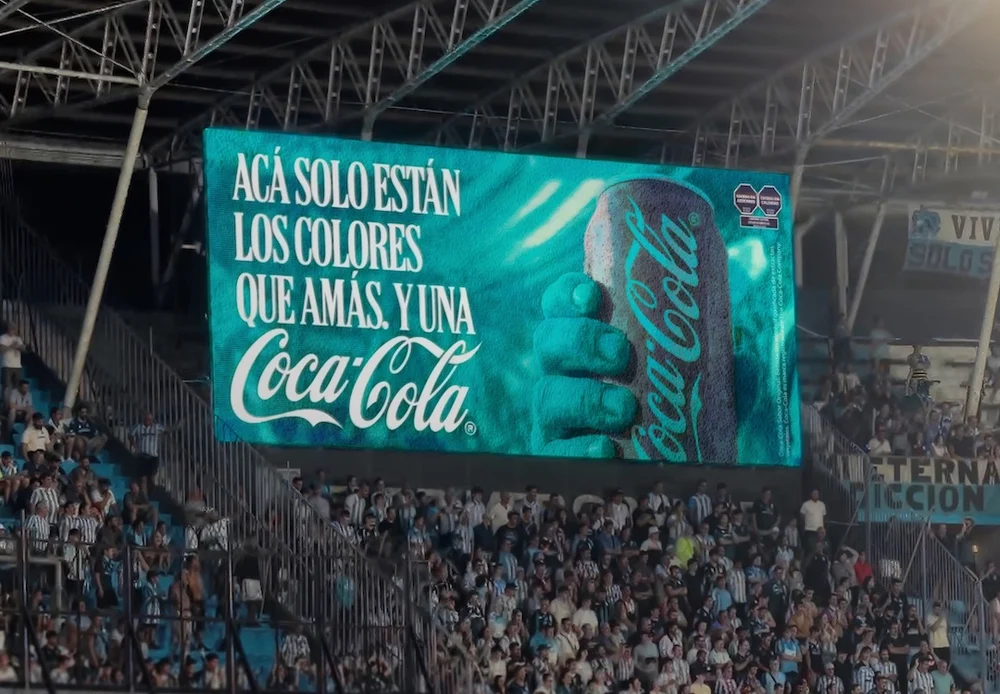 Coca-Cola optical illusion advert with a billboard showing a blue Coca-cola can that looks red